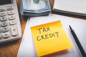 tax documents and a note that reads tax credit