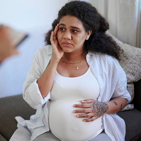 Concerned pregnant woman at a medical appointment