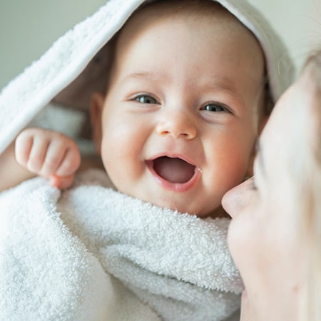 smiling baby with adoptive mom