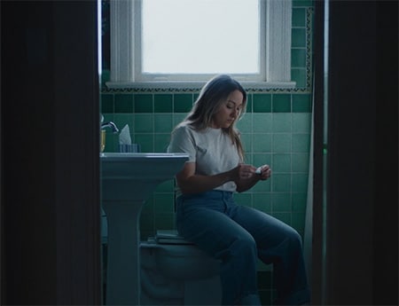 Girl in the bathroom checking pregnancy test