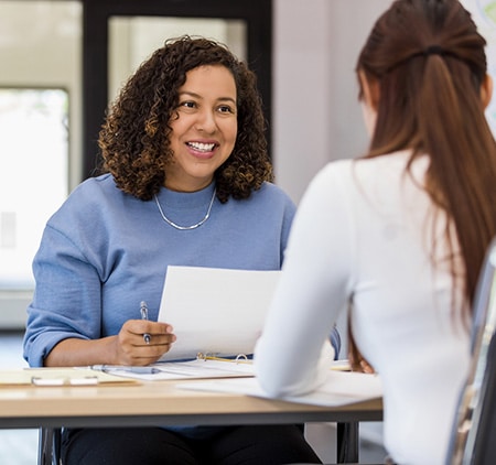 an HR rep helping a coworker with adoption reimbursement info